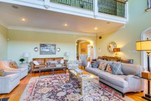 a living room with couches and a rug at Riverfront North Augusta Home with Private Pool! in North Augusta