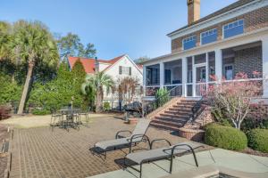 a patio with chairs and tables in front of a house at Riverfront North Augusta Home with Private Pool! in North Augusta