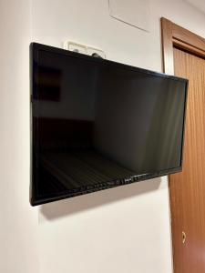 a flat screen television hanging on a wall at Pension La Orozca in Benidorm