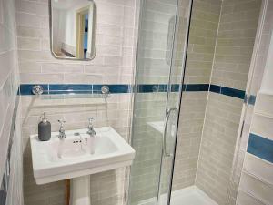 a bathroom with a sink and a shower at Georgian Loft Apartment - Central Bath in Bath