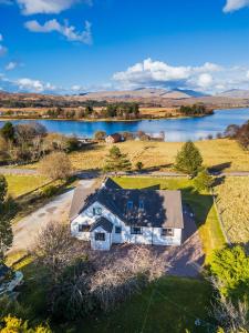 an aerial view of a house with a lake at Brackenbrae Holiday Cottage in Acharacle