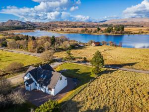 an aerial view of a house next to a lake at Brackenbrae Holiday Cottage in Acharacle
