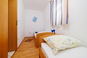 two beds in a small room with a flag at Apartment Julija in Povile