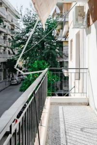 una escalera que conduce a un edificio con balcón en Orsiida Family apartment Volos en Volos