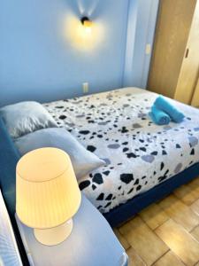 a bedroom with a bed with a black and white cow print at Maison Confort & Silence, Jardin & Barbecue in Marseille
