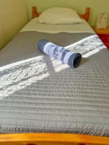 a roll of paper laying on a bed at Maison Confort & Silence, Jardin & Barbecue in Marseille