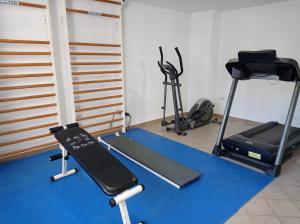 a gym with two treadmills and two exercise bikes at Palmeras III Solo Familias Serviplaya!!! in Gandía