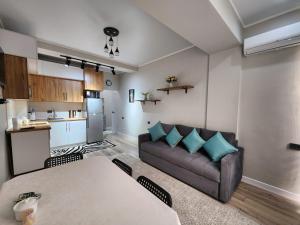 a living room with a couch and a table at Diamond Apartment in Osh