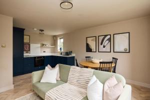 a living room with a couch and a table at The Twickenham Wonder - Lovely 1BDR Flat with Parking in Twickenham