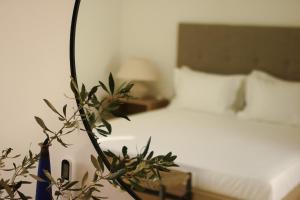 a bedroom with a bed and a plant in the foreground at Villa Boa Milos 4 Bedrooms near Adamas in Adamantas +31 photos