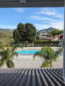 a view of a swimming pool from the porch of a house at Villa Dafne in Torrenova