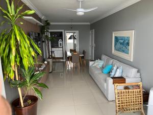 a living room with a couch and a table at Guaruja Praia de Pitangueiras frente ao mar in Guarujá