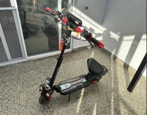 a scooter parked on the floor in a room at Аренда Электросамокатов в Шарм Эль Шейхе in Sharm El Sheikh