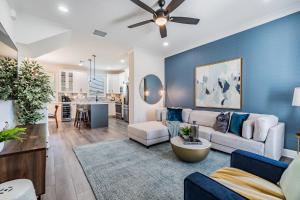 a living room with a couch and a ceiling fan at Amalie Arena, Raymond James, Armature Works in Tampa