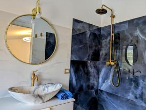 a bathroom with a sink and a mirror at Villa Dafne in Torrenova