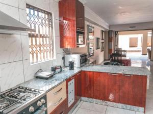 a kitchen with a stove and a counter top at Khutso Boutique Hotel in Hazyview