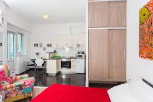 een keuken en een woonkamer met een rood tapijt bij Apartment Banjska in Dubrovnik