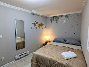 a bedroom with a bed and a mirror at Room at the Heart of East Village in New York