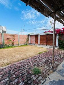 een bakstenen loopbrug voor een bakstenen gebouw bij Bungalow acogedor cerca a todo in San Bartolo