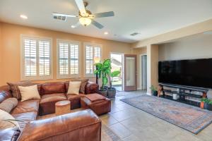 a living room with leather furniture and a flat screen tv at Charming Henderson Home 6 Mi to Lake Las Vegas! in Las Vegas