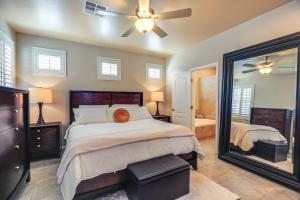 a bedroom with a large bed and a mirror at Charming Henderson Home 6 Mi to Lake Las Vegas! in Las Vegas