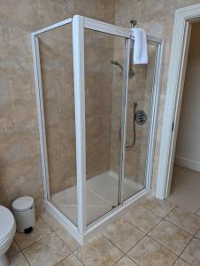 a shower with a glass enclosure in a bathroom at The Western Citypoint Apartments in Galway