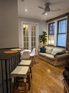 a living room with a couch and a table at Cozy Room at a shared Apartment East Village in New York