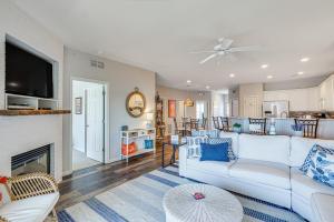 a living room with a white couch and a fireplace at Dine Al Fresco on Balcony Osage Beach Condo! in Osage Beach