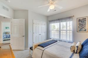 a bedroom with a bed and a ceiling fan at Osage Beach Lakefront Condo with Screened Balcony! in Osage Beach