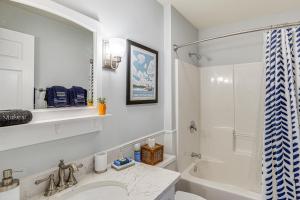 a white bathroom with a sink and a shower at Dine Al Fresco on Balcony Osage Beach Condo! in Osage Beach +17 photos