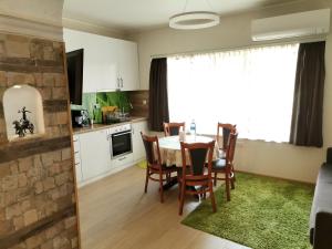 a kitchen and dining room with a table and chairs at Guest Apartment Monarch in Smolyan