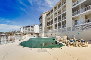 an apartment building with a volleyball court in the courtyard at Osage Beach Lakefront Condo with Screened Balcony! in Osage Beach