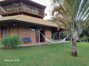 a house with a hammock in front of it at Recanto da Natureza in Brotas