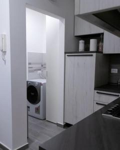 a kitchen with a refrigerator and a washing machine at Appartamento La Corte in Levico Terme