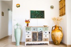 a room with two vases and a dresser at Villa Mina in Ostuni