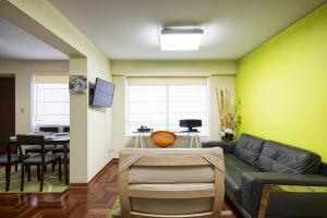 a living room with a couch and a table at La Masia Apartments in Lima