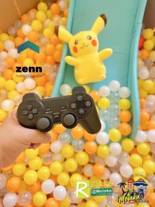 a person holding a video game controller in a pool of balls at The Bali Residences Premium Suites Melaka in Melaka