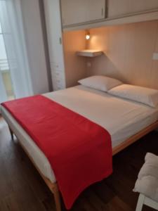 - un grand lit avec une couverture rouge dans l'établissement Home Sweet Home, à Alghero