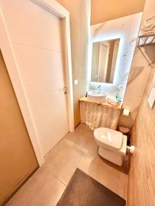 a bathroom with a sink and a toilet and a mirror at Fiera Maison in Verona