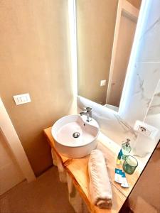 a bathroom with a white sink and a mirror at Fiera Maison in Verona