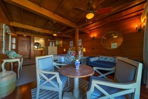 a living room with a table and chairs at Playa Cativo Lodge in Esquinas