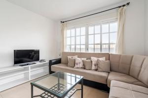 a living room with a couch and a tv at Centric and spacious flat with free car park in Seville