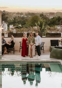 a group of people standing next to a swimming pool at Layla Tulum - Adults Only in Tulum