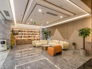 a lobby with couches and a table and shelves at Veegle By Landison Ningbo in Ningbo