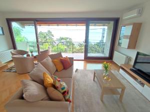 a living room with a couch and a table at Dorka Villa in Tihany