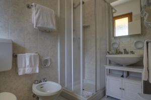 a bathroom with a shower and a sink and a toilet at Dimora Punta Ala in Punta Ala