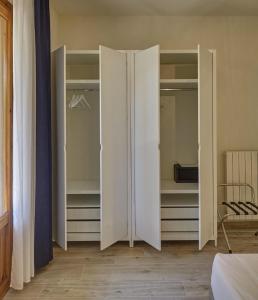 a pair of white closet doors in a bedroom at Dimora Punta Ala in Punta Ala