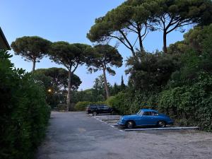 a blue car parked in a parking lot at Dimora Punta Ala in Punta Ala