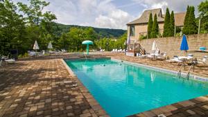 a large swimming pool with chairs and umbrellas at Mtn Chalet Wpool-hot Tub-gym-game Room-sauna in Gatlinburg