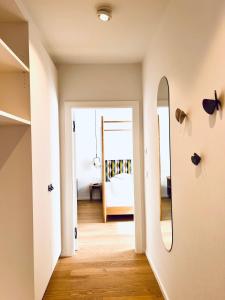 a hallway with a mirror and a bedroom at Hotel Gartenresidence Zea Curtis in Merano